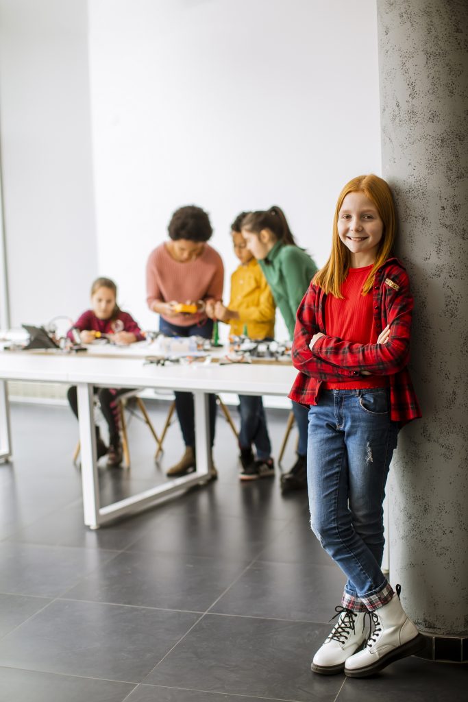 cute little girl standing in front of group of ki 2025 02 22 16 06 02 utc