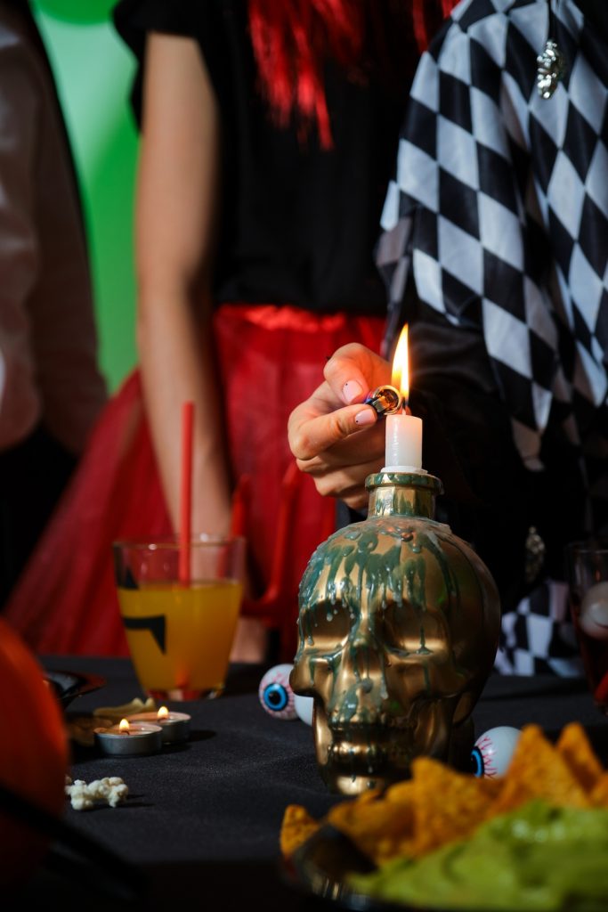 woman lights a candle on a skull with a lighter at 2025 03 31 10 48 35 utc 1