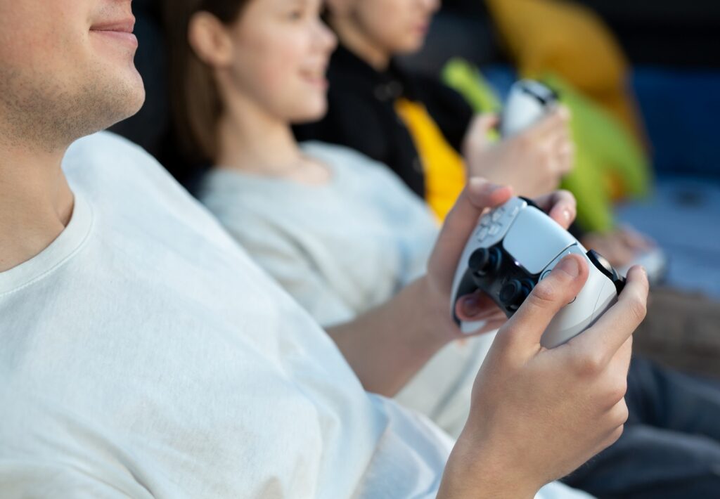 close up on the hands of children playing console 2026 01 07 00 41 42 utc e1773138535203