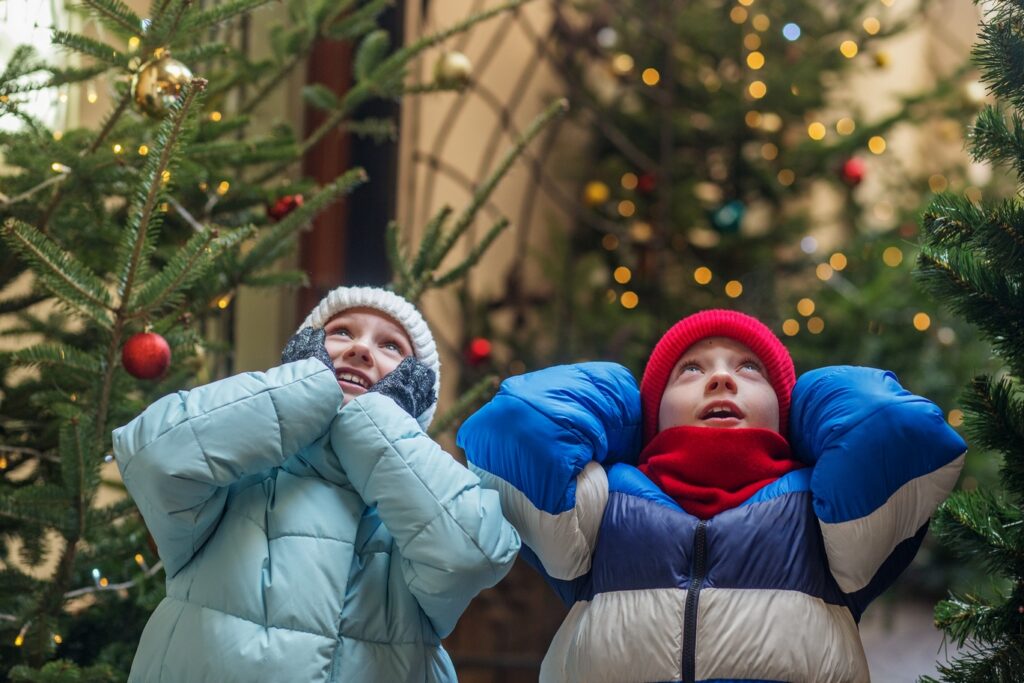 excited children looking up at christmas trees in 2026 01 09 12 10 11 utc