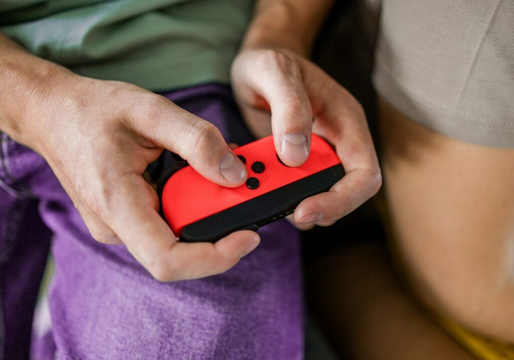 hands using game controller playing video games 2026 01 08 06 58 12 utc e1773138499423