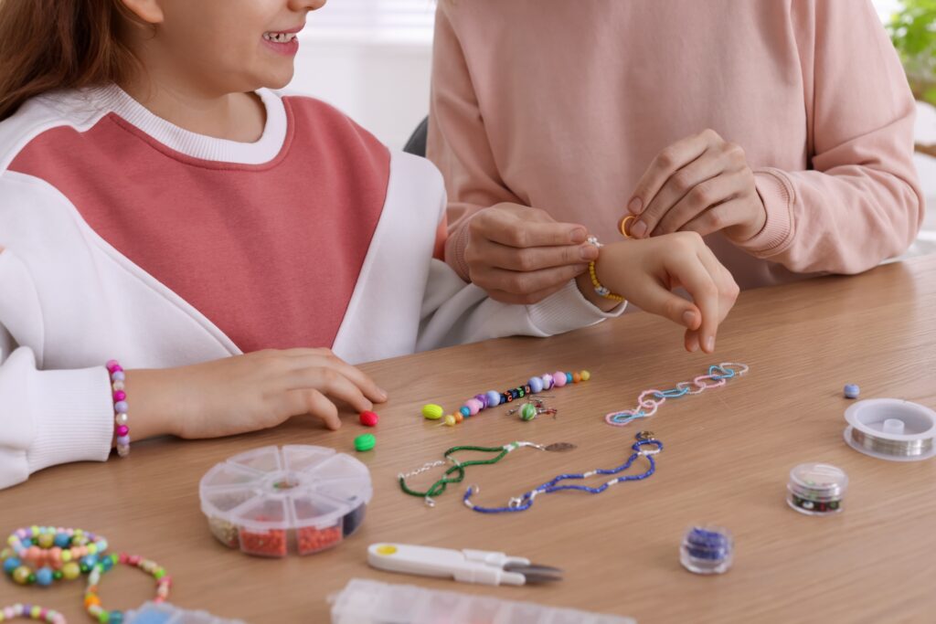mother with her daughter making beaded jewelry at 2026 01 09 18 50 13 utc