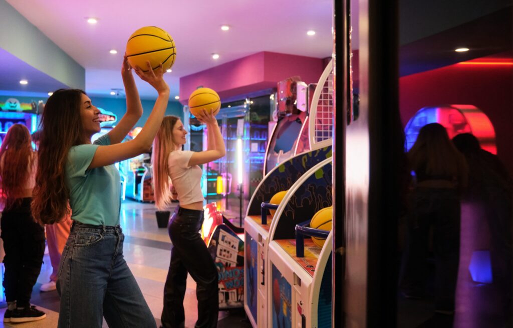 two girls playing basketball arcade game in amusem 2026 01 09 10 03 53 utc e1773140502429